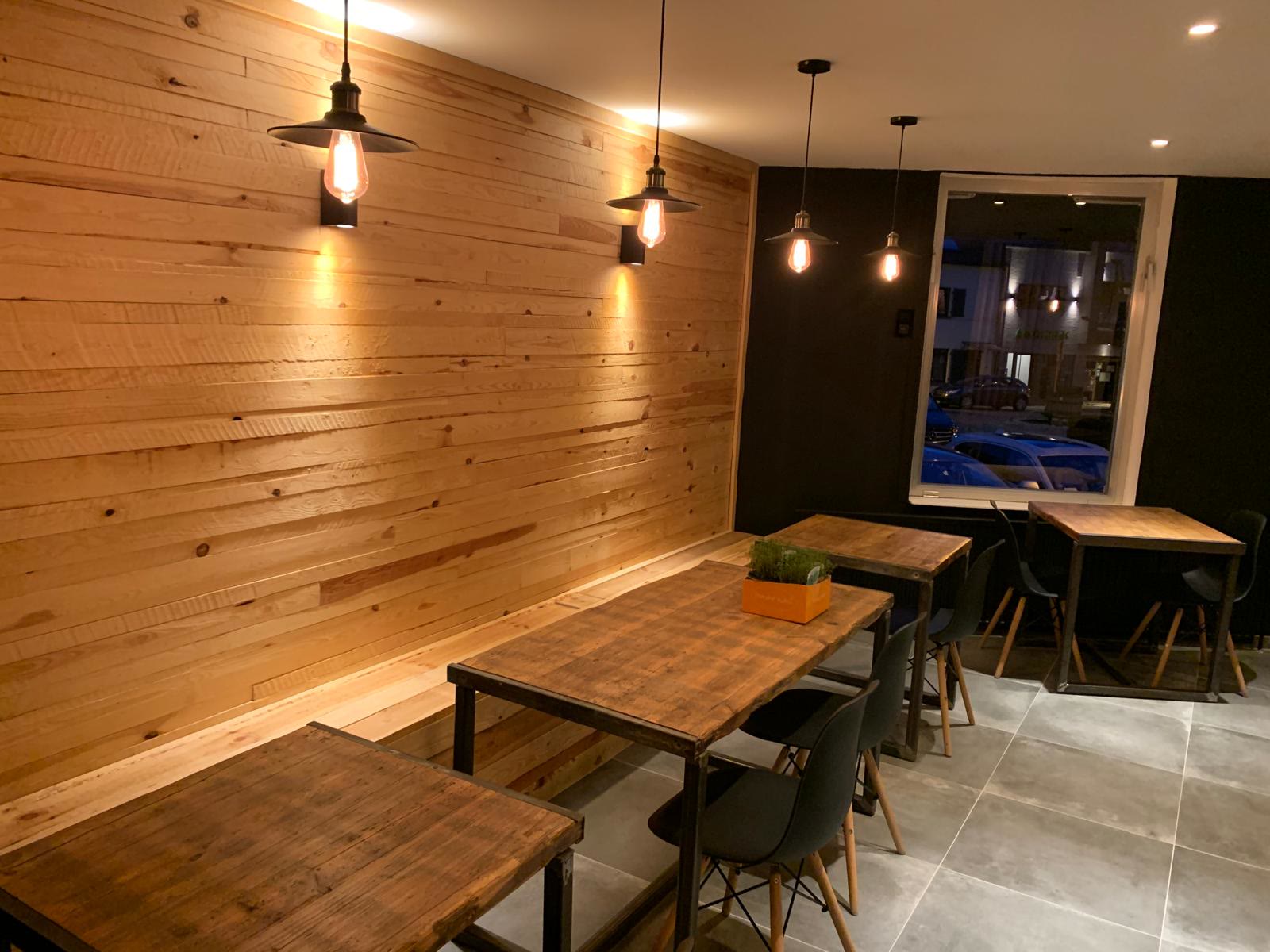 Coffee bar with timber wall and warm pendant lights
